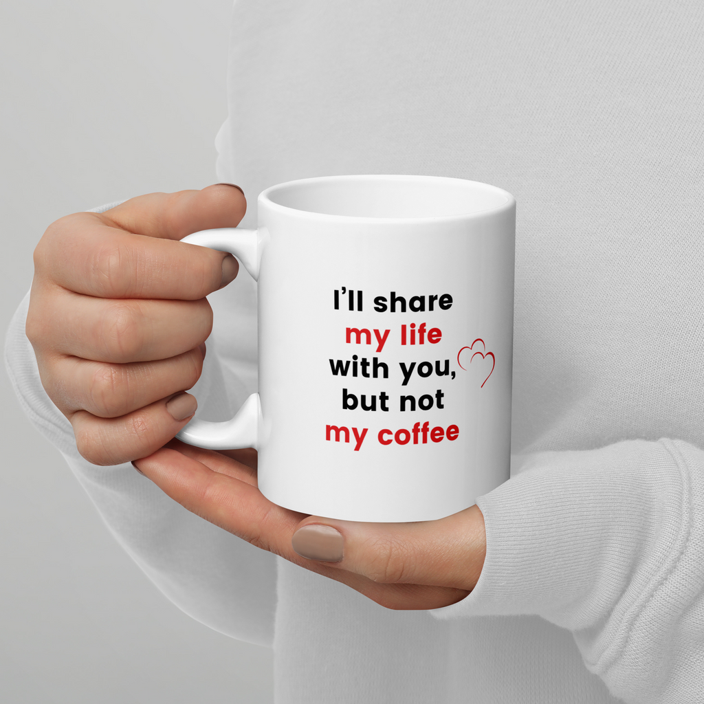 person holding white mug with words I'll share my life with you, but not my coffee