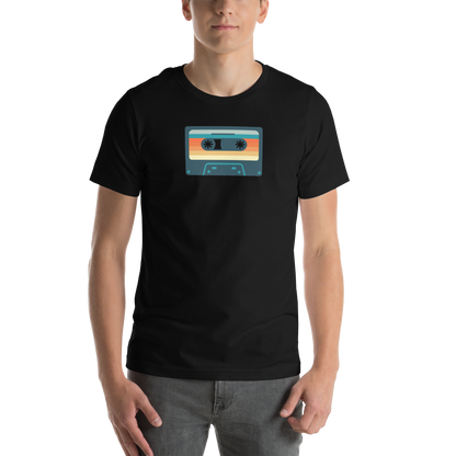 Person wearing a black t-shirt with a colorful cassette tape design 